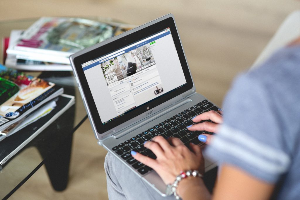 woman typing on Facebook