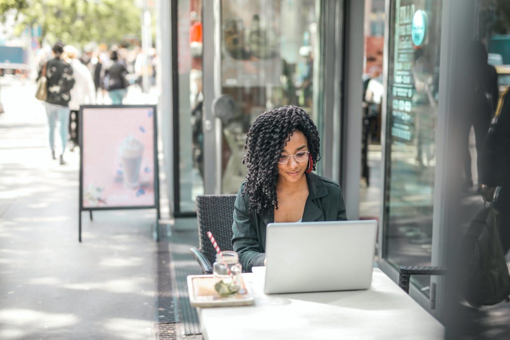 woman working outside cafe