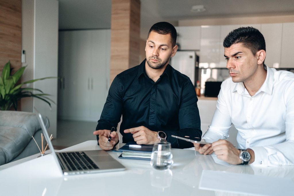 men looking at laptop